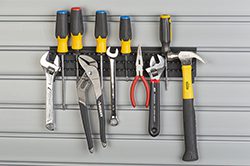 A Tool Grip On A White Color Wall With Tools